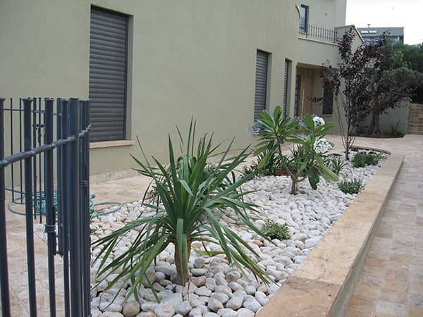 River Pebbles with Plantings Alongside the Entrance Path